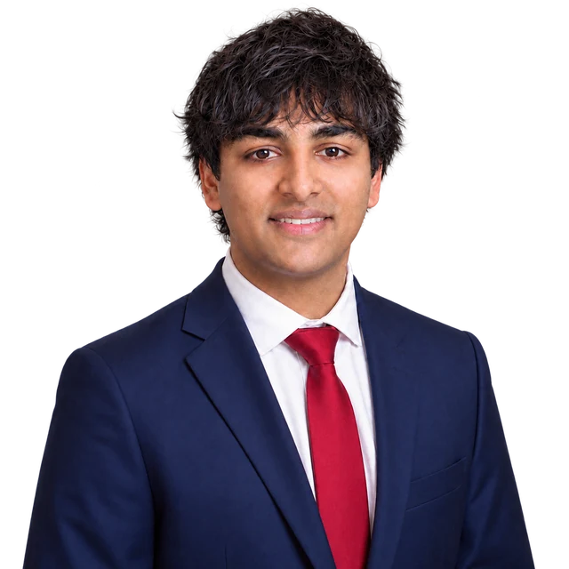 Portrait of Bilal Ghanty in a navy suit and red tie